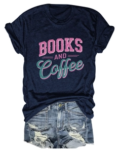 Flat lay of Books and Coffee graphic navy T-shirt paired with distressed denim shorts