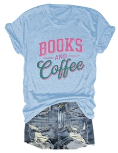 Flat lay of Books and Coffee graphic t-shirt with distressed denim shorts on white background