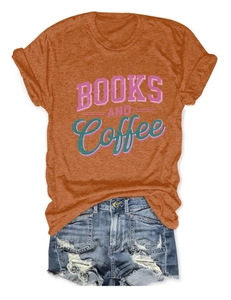 Flat lay of Books and Coffee orange cotton T-shirt with distressed denim shorts set