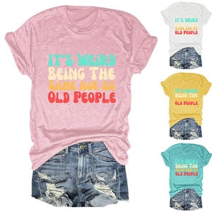 Detail view of cotton blend T-shirt with vintage colorful text and ripped denim shorts