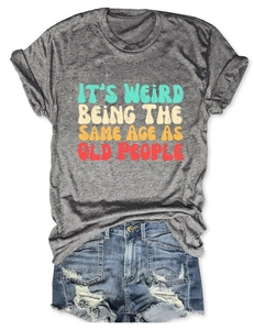 Flat lay of a grey slogan T-shirt with denim shorts featuring vintage lettering