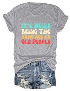 Flat lay of gray t-shirt with slogan text and distressed denim shorts with frayed hems