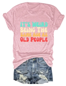 Flat lay of pink cotton T-shirt with vintage slogan and distressed denim shorts