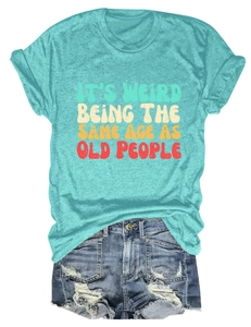 Close-up of retro slogan print on turquoise cotton t-shirt with ripped denim shorts
