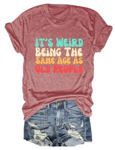 Flat lay of vintage rust cotton T-shirt with humorous slogan and ripped denim shorts