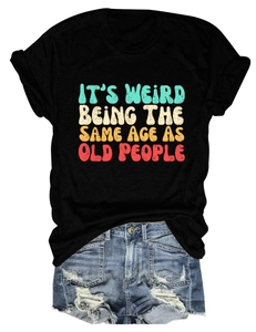 Close-up of retro colorful text on black cotton T-shirt with light blue denim shorts