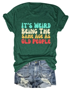 Flat lay of green t-shirt with vintage text and distressed denim shorts on white background