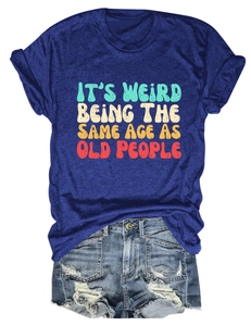 Macro detail of 'IT'S WEIRD BEING THE SAME AGE AS OLD PEOPLE' slogan on a purple t-shirt