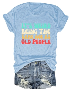 Flat lay of light blue T-shirt with vintage slogan print and distressed denim shorts