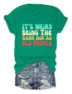 Flat lay of green slogan T-shirt with distressed denim shorts for a casual summer look