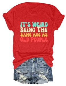 Flat lay of red cotton t-shirt with vintage slogan print and distressed denim shorts