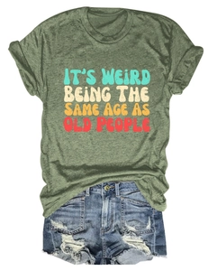 Flat lay of green slogan t-shirt with blue distressed denim shorts and vintage lettering