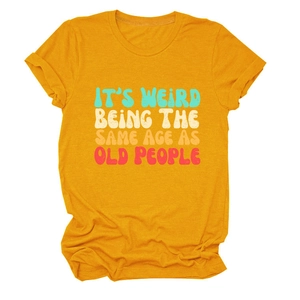 Detail of colorful slogan print on a yellow cotton t-shirt for women in flat lay view