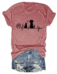 Flat lay of a red paw print t-shirt tucked into distressed denim shorts with frayed edges