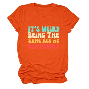Close-up of retro text print and cotton fabric texture on orange crewneck T-shirt