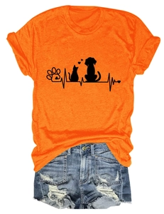 Close-up of orange t-shirt with black cat dog paw and heartbeat line graphic print