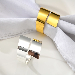 Polished metal napkin rings in gold and silver finish with minimalist blade design