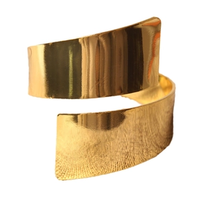 Polished gold spiral napkin ring with smooth finish and textured metal surface details
