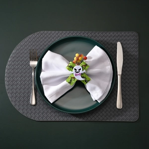 Detail of Halloween napkin ring with ghost felt decor, green bow and yellow berries