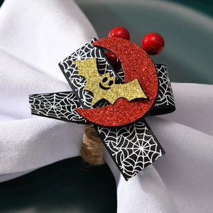 Halloween napkin ring with spider web ribbon and glitter bats on white napkin