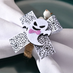 Detail of Halloween ghost napkin ring with pink sequin bow and woven hemp rope loop