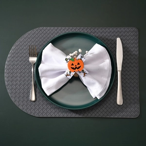 Detail of handmade pumpkin napkin ring with spider web ribbon for Halloween table setting