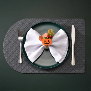Close-up of Halloween pumpkin napkin ring with orange felt and rustic hemp rope detail