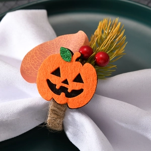 Handmade Halloween pumpkin napkin ring with twine loop and festive berry decorations