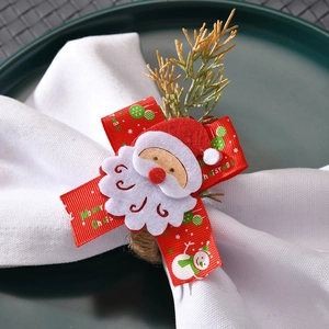 Detail of handmade Santa Claus napkin ring with festive red ribbon and rustic hemp rope