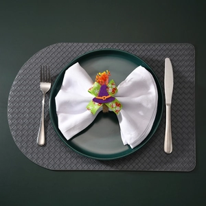Detail of handmade Halloween napkin ring featuring purple witch hat and green festive bow