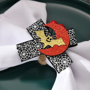 Detail of Halloween napkin ring featuring spider web ribbon, glitter bat and moon accents