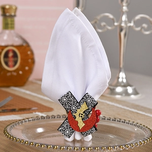 Halloween napkin ring with spider web pattern, glitter moon and bat on white fabric