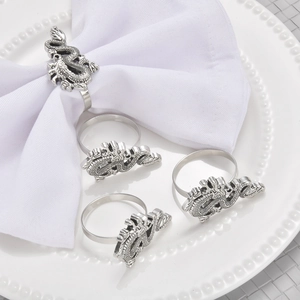 Set of 4 silver dragon napkin rings with embossed metal texture for dining table decor