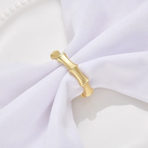Detail of champagne gold bamboo napkin ring with elegant matte brushed metal texture