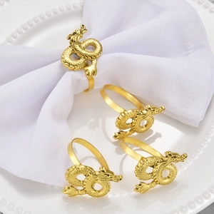 Set of 4 golden dragon napkin rings featuring detailed scales and a metallic finish