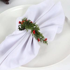 Christmas wreath napkin ring with green pine needles and red berries for table decor