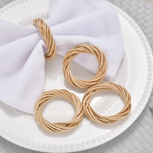 Set of 4 handmade natural rattan napkin rings on a white plate with minimalist decor