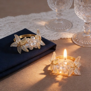 Detail of gold metal wire napkin ring with crystal flower beads on a dining table