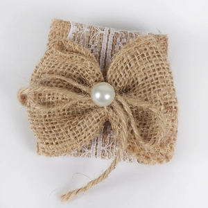 Handmade burlap napkin ring with lace trim and faux pearl bow for rustic weddings