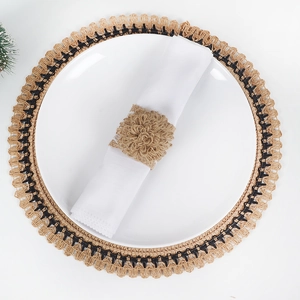Detail of burlap napkin ring with jute flower and woven placemat for table decor