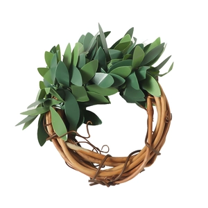 Artificial green leaf wreath with natural brown rattan base for festive table decoration