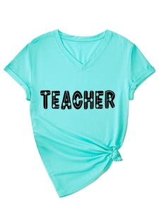 Detail of mint green V-neck Teacher t-shirt with clover print and knotted hem