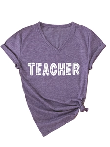 Detail of purple V-neck T-shirt with TEACHER print and clover pattern on cotton fabric