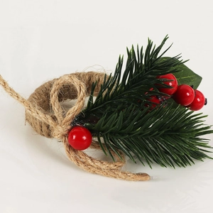 Detailed close-up of handmade jute twine napkin ring with festive pine needles and red berries