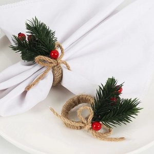 Detailed view of handmade Christmas napkin rings with pine needles and red berries décor