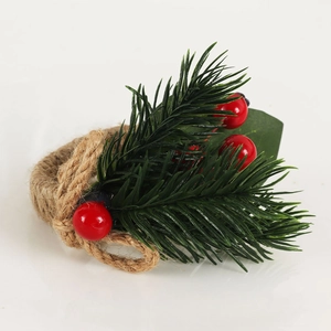Detail of Christmas napkin ring featuring pine needles red berries and woven twine rope