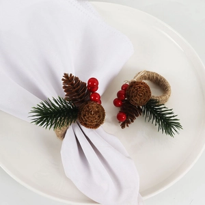 Close-up of pine needles, pine cones, and red berries on a woven napkin ring