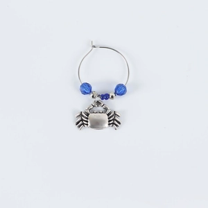Detailed view of silver crab charm wine glass marker with deep blue crystal beads