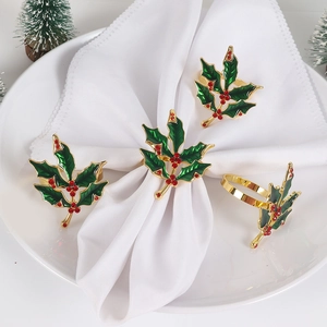 Detail of Christmas holly leaf napkin ring with green enamel and red rhinestones