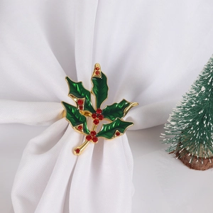 Detail of Christmas holly leaf napkin ring with green enamel and red crystal berries